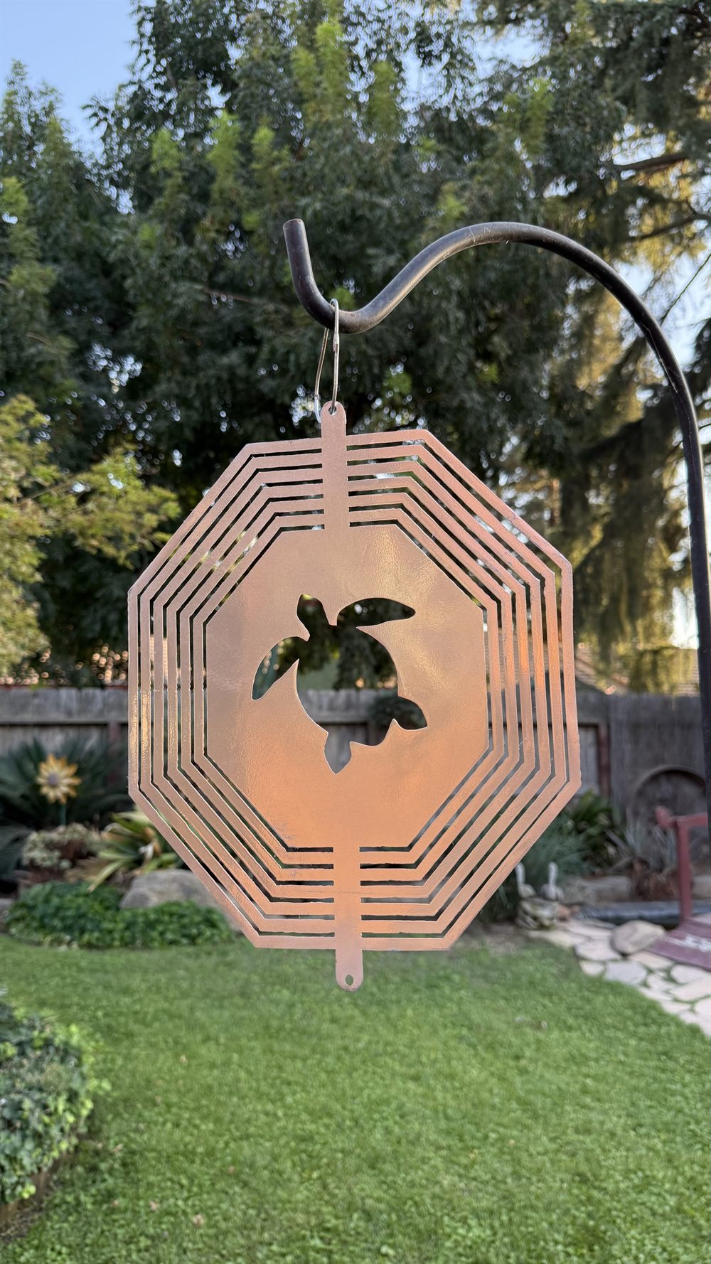 A steel turtle wind spinner inside a spinning sphere.
