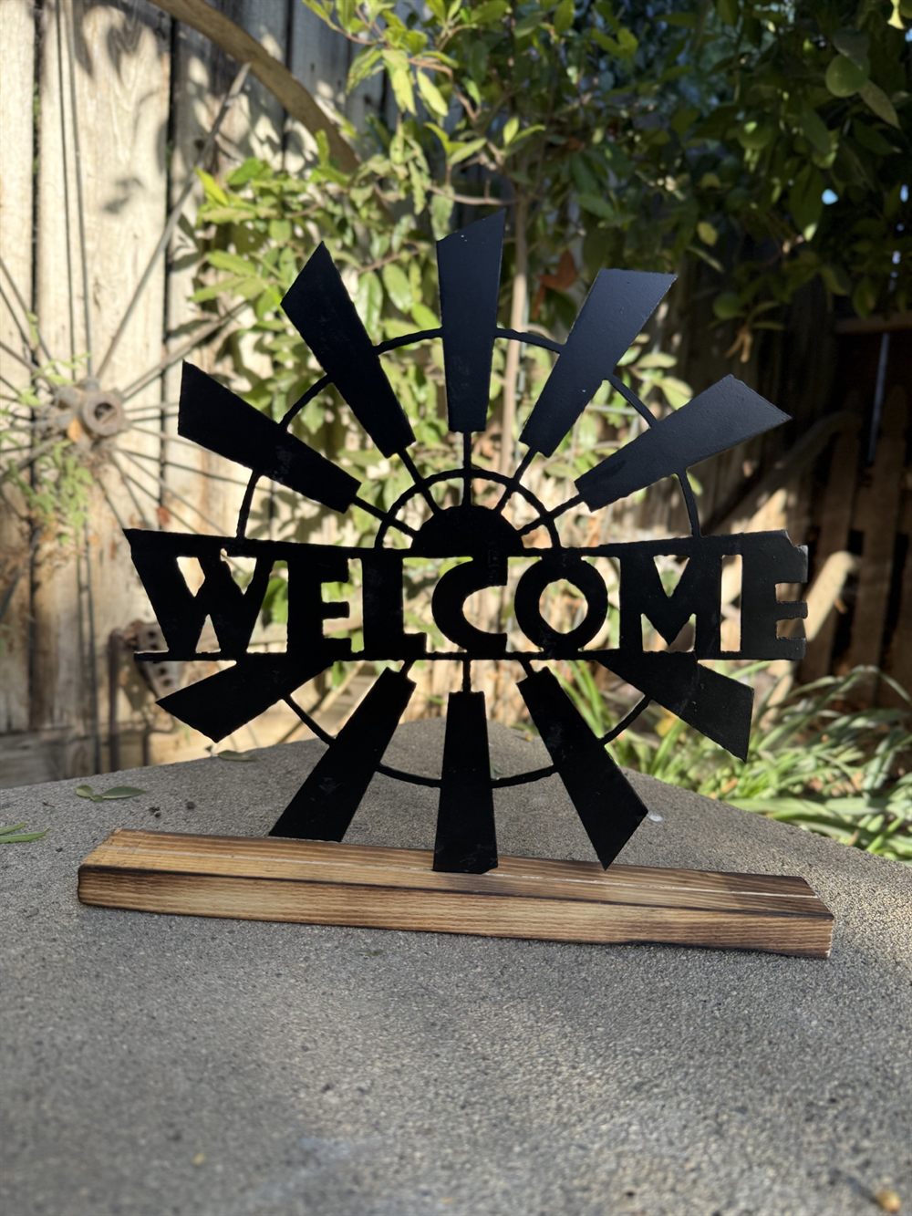 A steel Welcome sign with a windmill.